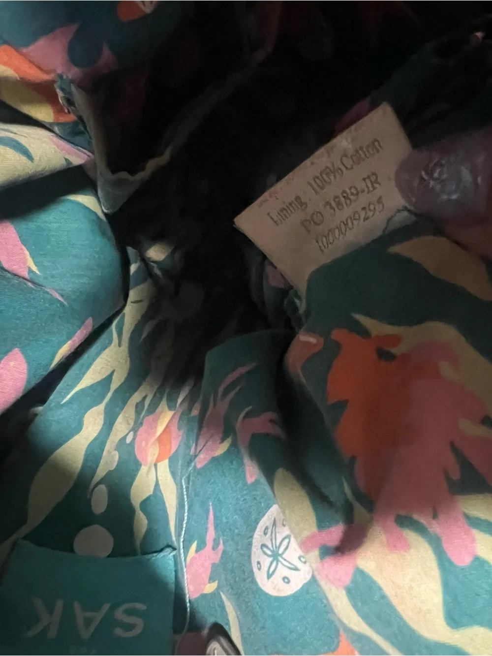 The Sak Black Knit Drawstring Backpack with Pink Floral Charm